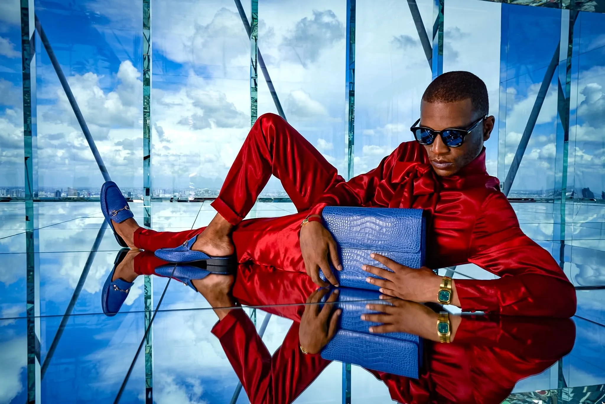 Red suit reclining, doubled in the mirrored floor
