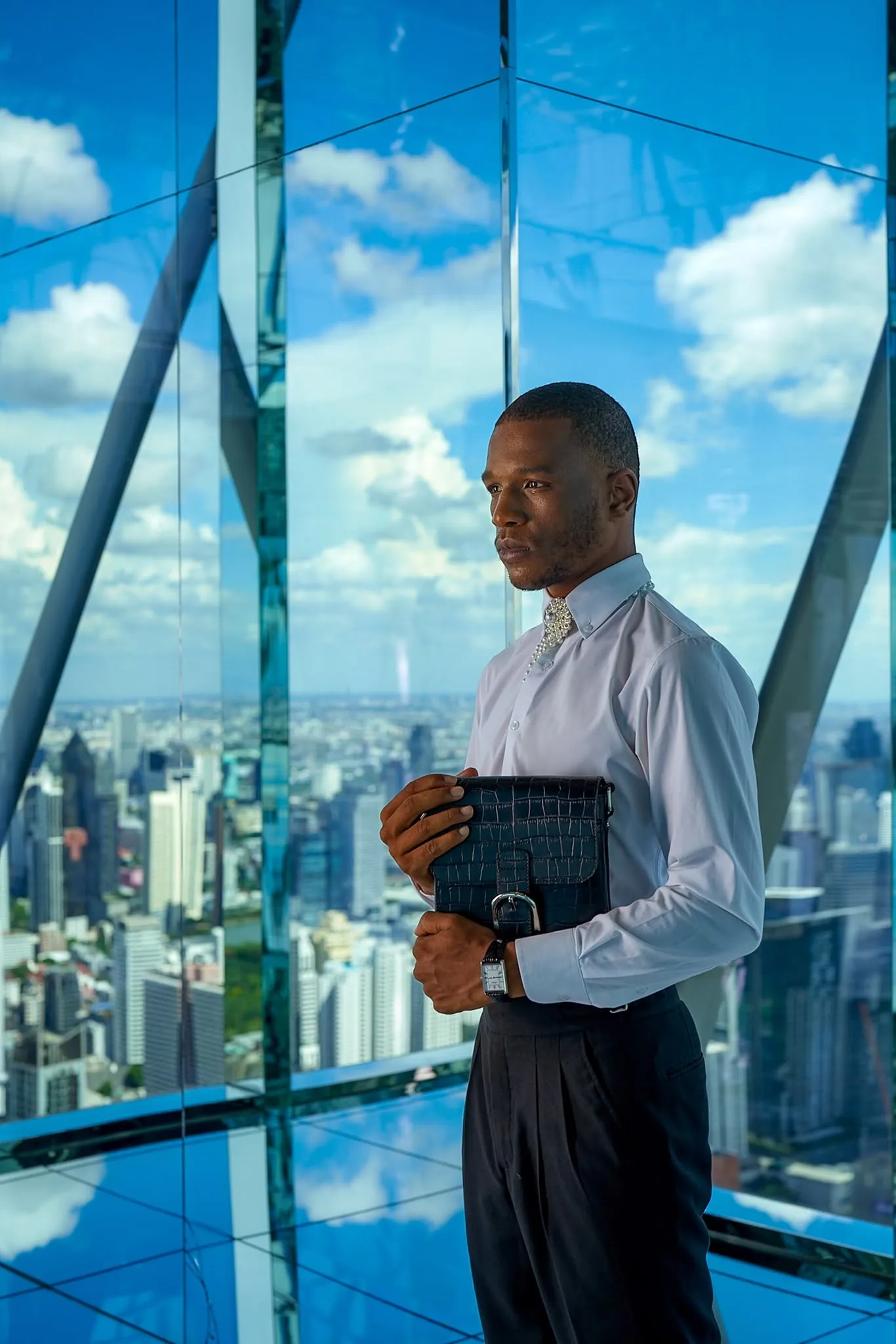 White shirt and black trousers at the window