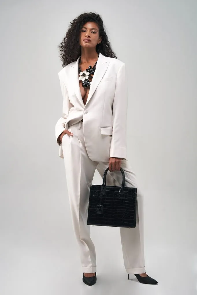 White suit with a leather tote