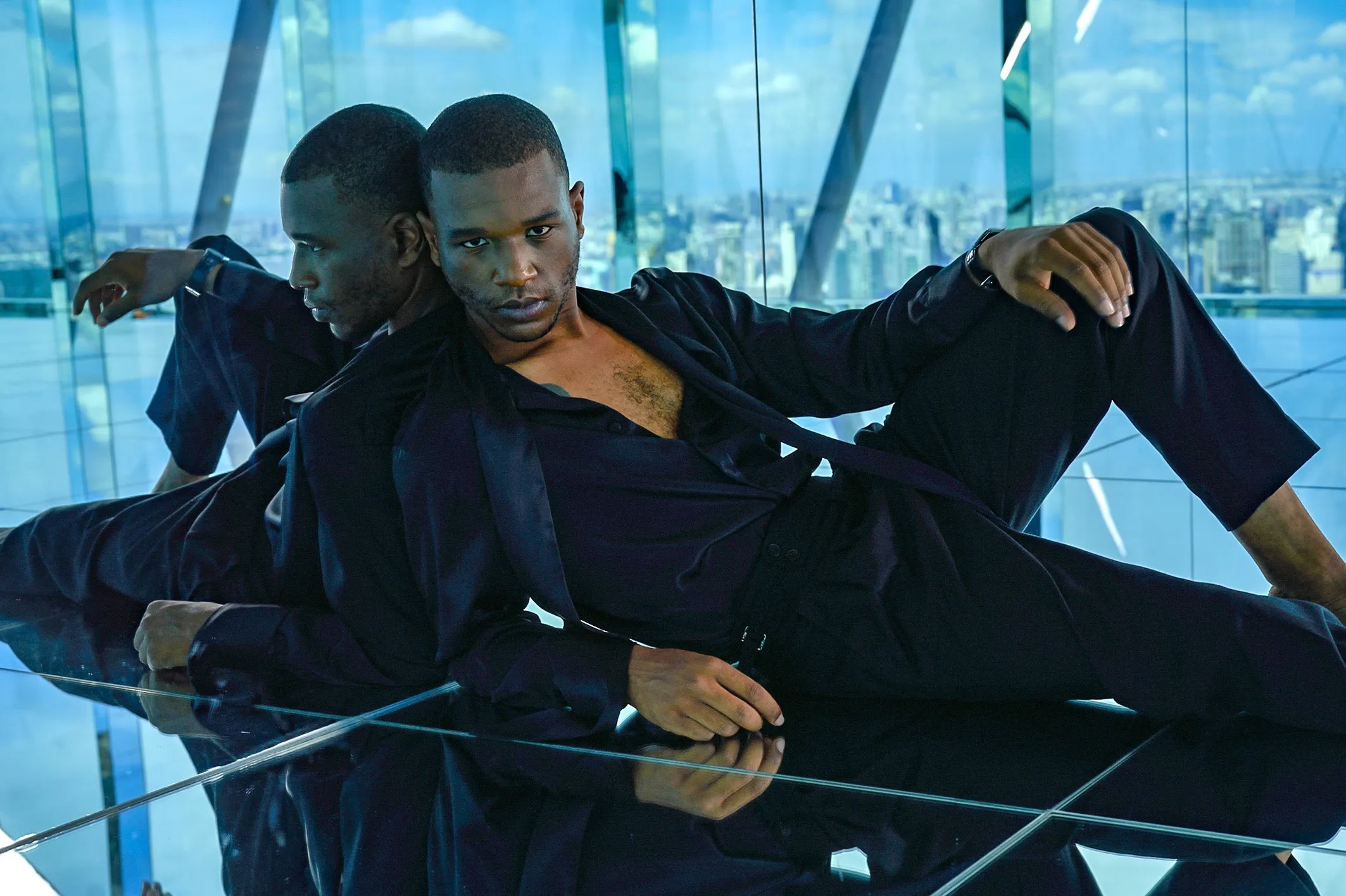 Close crop, black silk shirt open at the chest