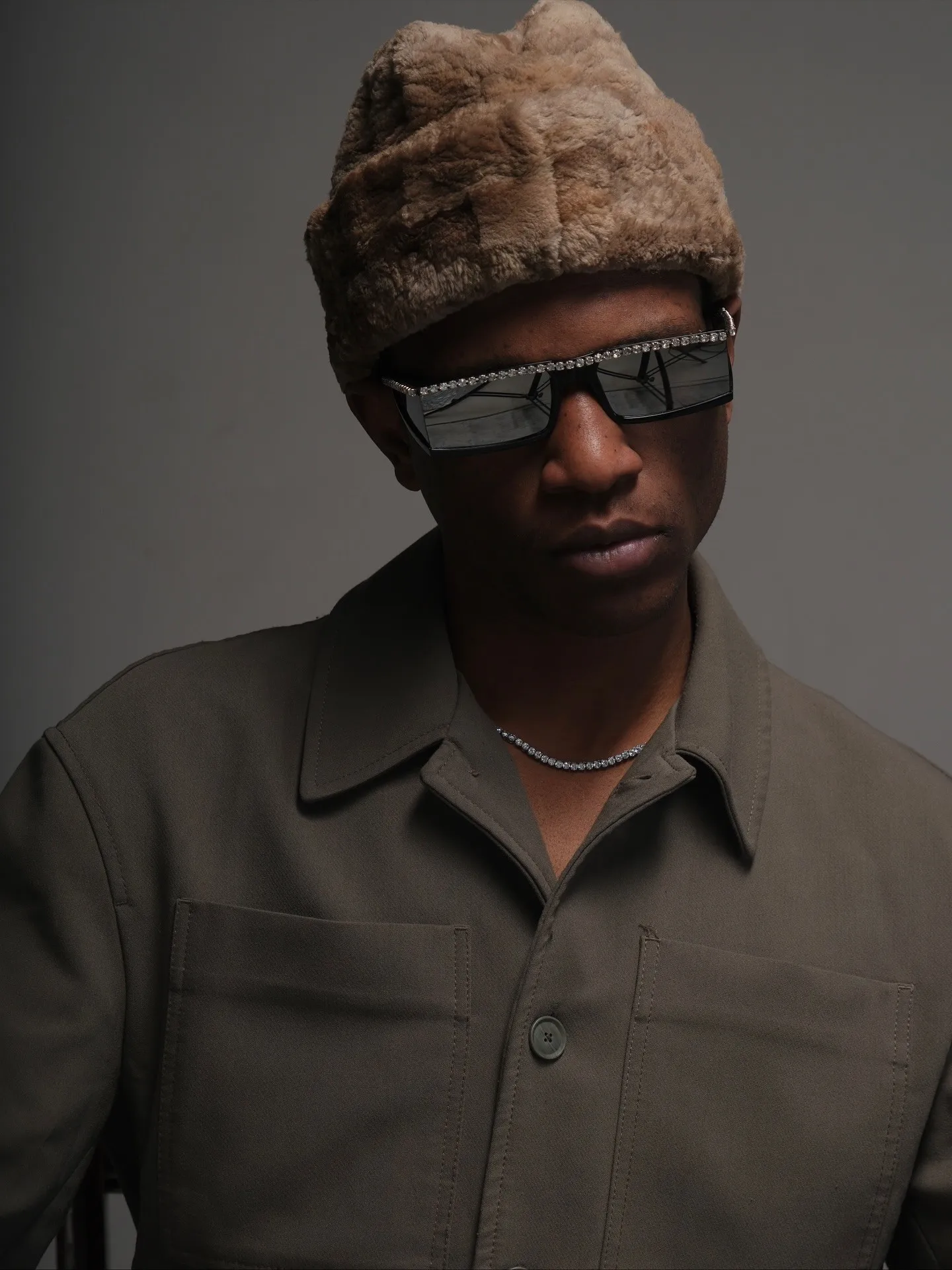 Travon Ridley-Evans in a fur hat and crystal sunglasses