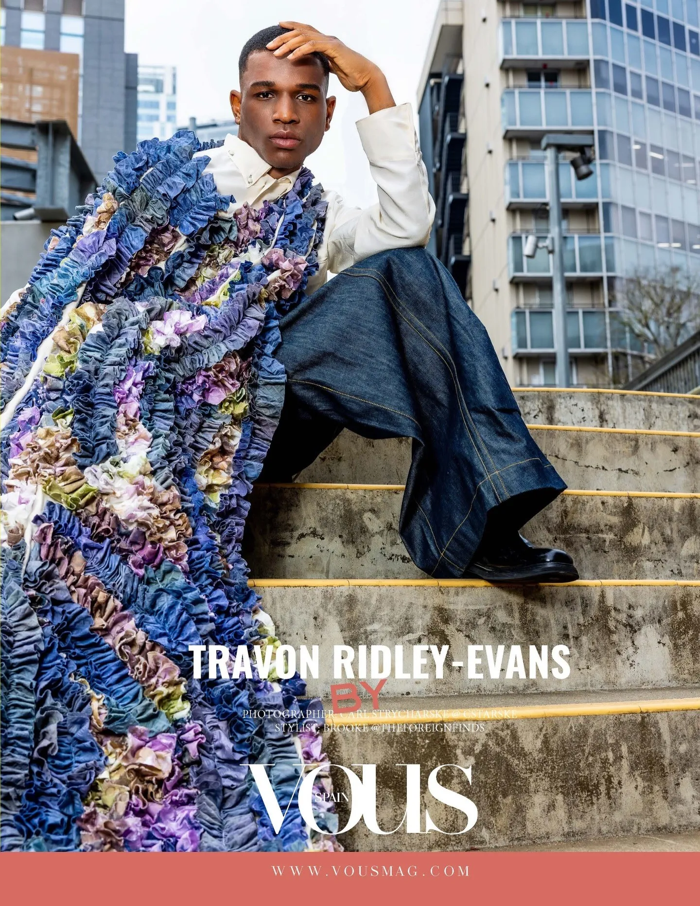 Travon Ridley-Evans seated on concrete steps in a denim ruffle stole